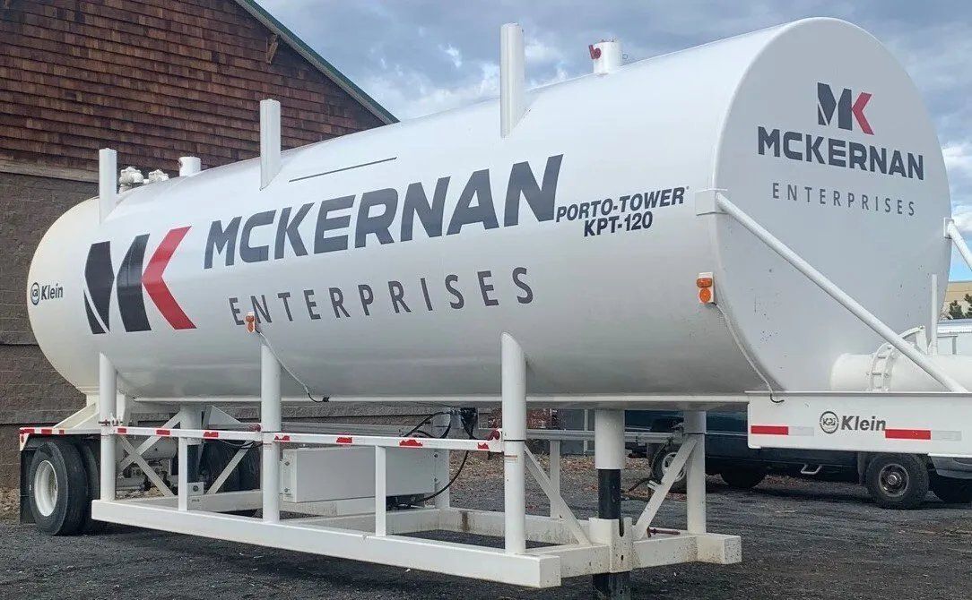 A large white tank with the words mckernan enterprises on it