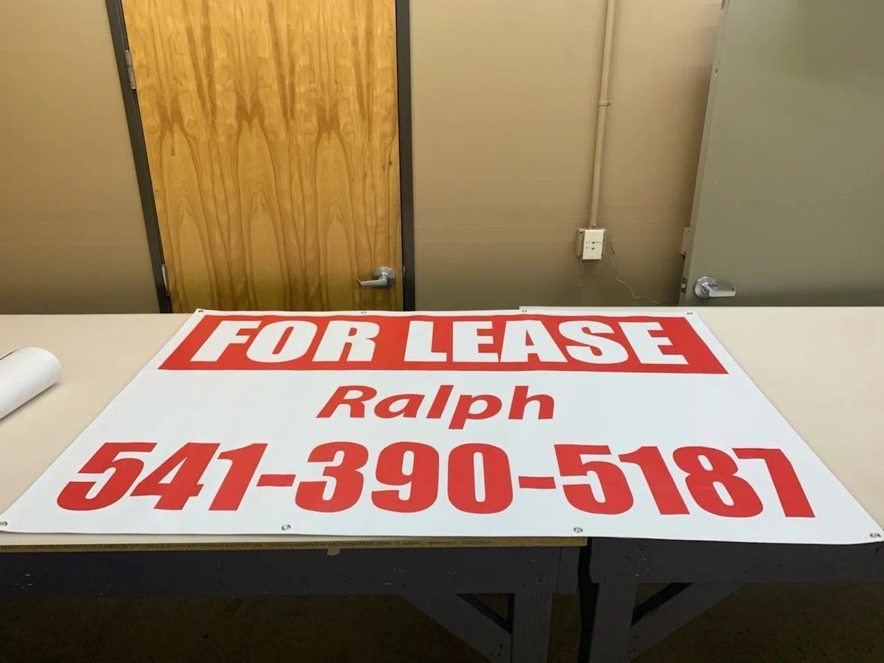A for lease sign is sitting on a table