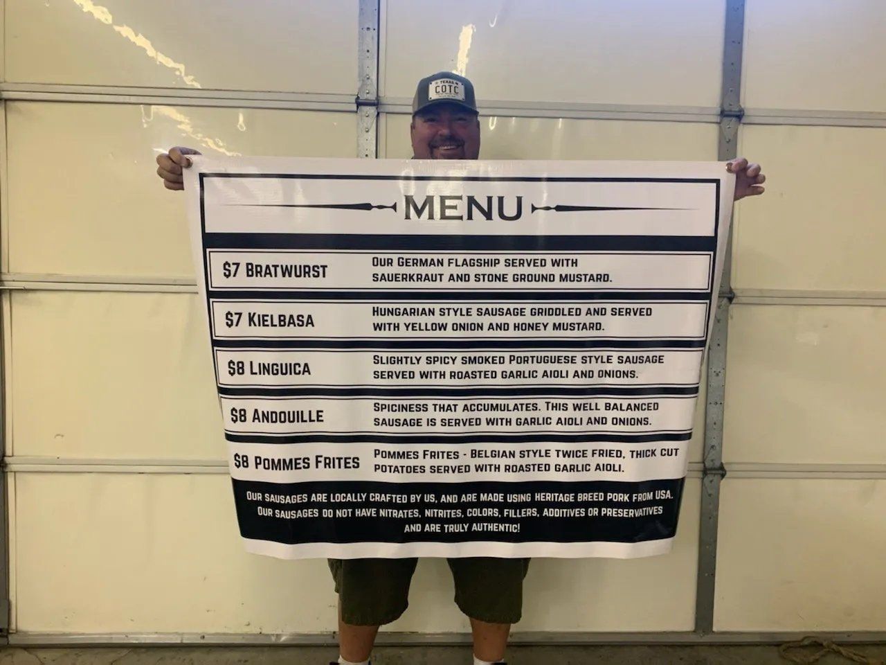 A man is holding a sign that says menu