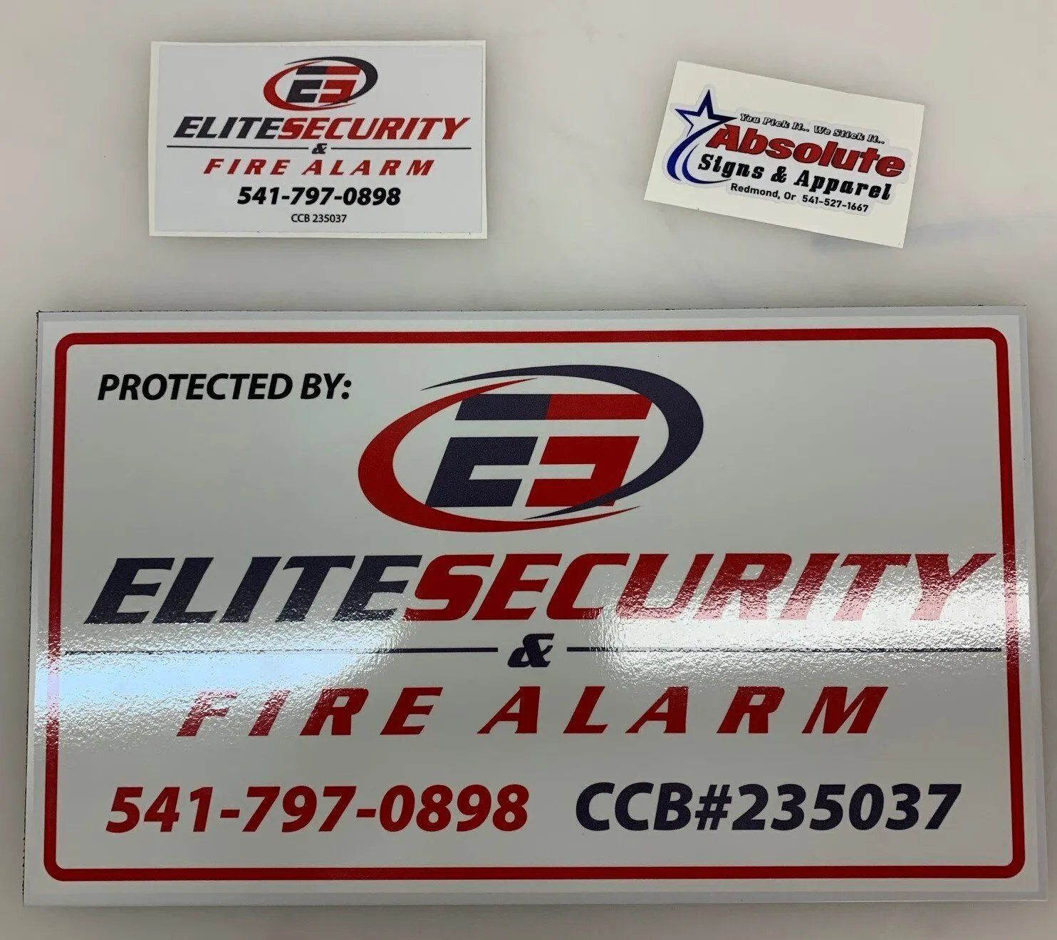 A sign that says elite security fire alarm on it
