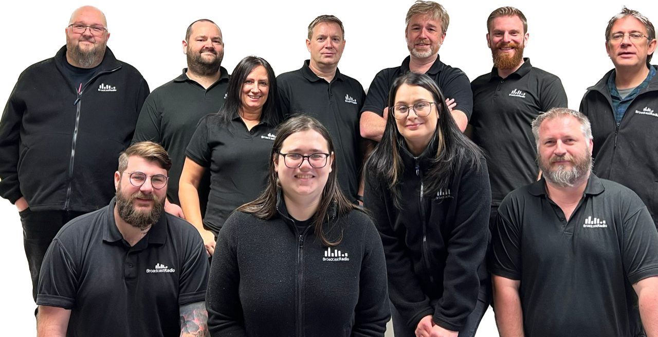 A group of people in black shirts are posing for a picture.