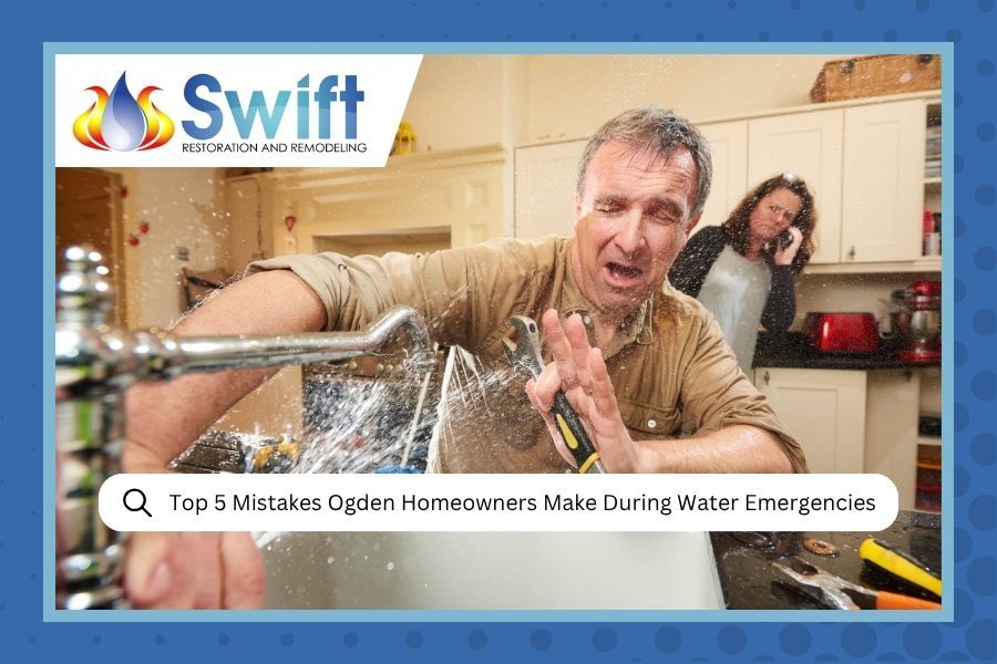 A man struggles to fix a spraying kitchen faucet while a person behind him calls for help on a phone; 