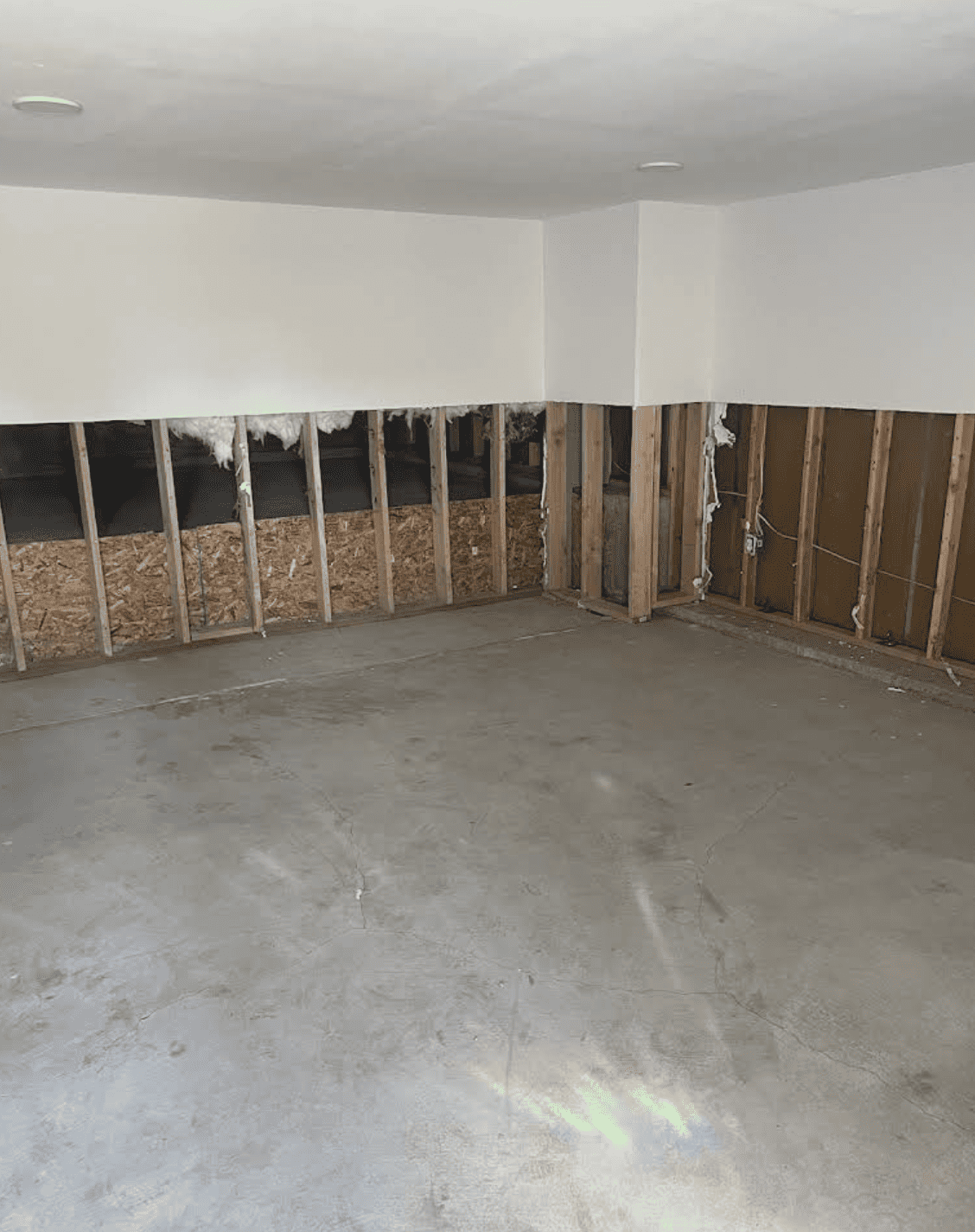 Flood cut drywall removal exposing wall cavities for drying