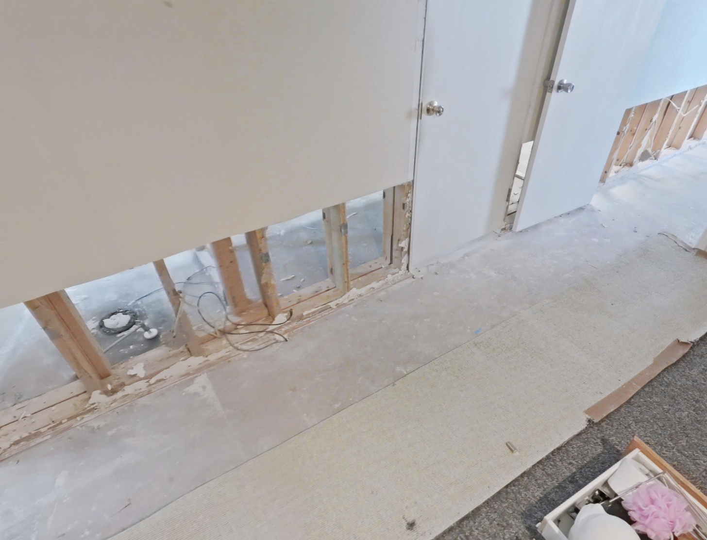 Bedroom water damage with removed baseboards and lower walls