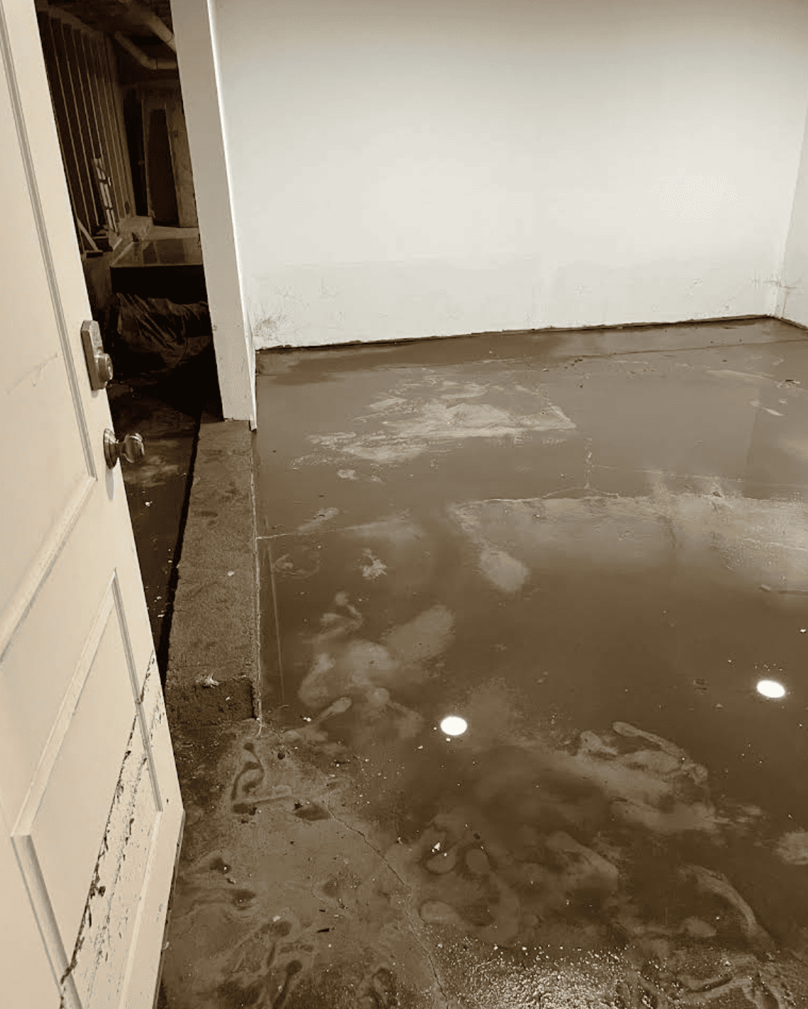 Water extraction pump removing flood water from basement entrance