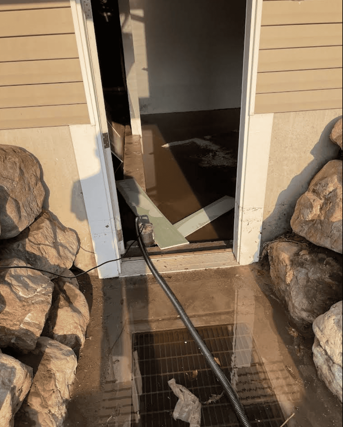 Standing water on basement floor with soaked area rug