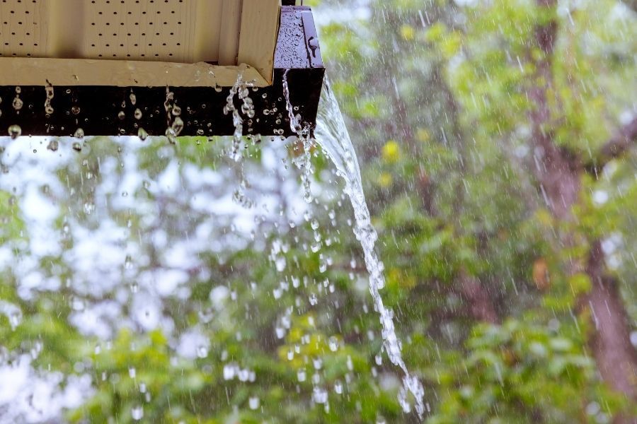 Overflowing gutters during a Utah summer storm