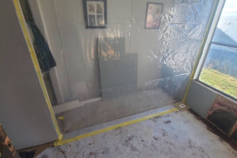 Professional containment barriers and negative air machines set up during restoration work