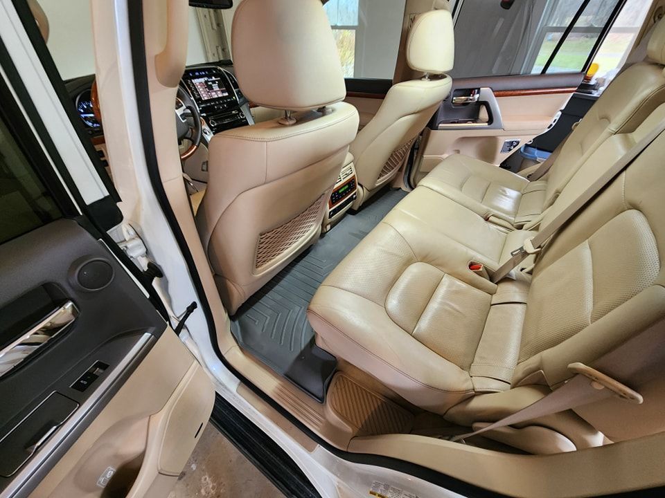 The interior of a white car with tan leather seats