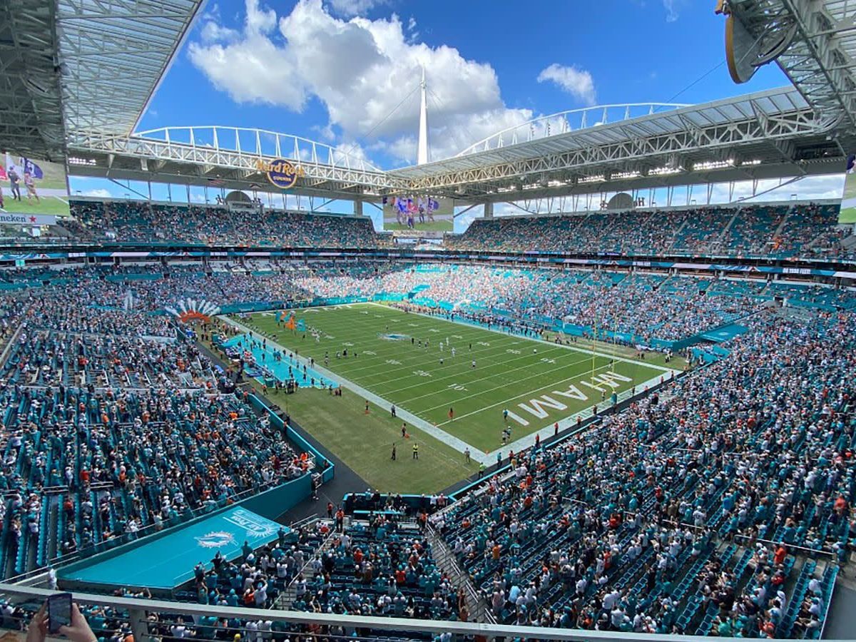 A stadium filled with people watching a football game.
