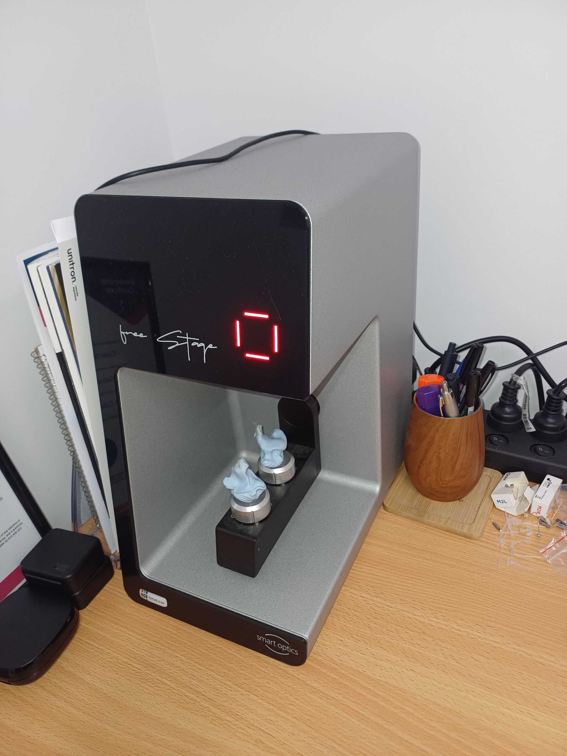 A Person is Putting a Hearing Aid in a Woman 's Ear — Clayton Hearing in Pialba, QLD