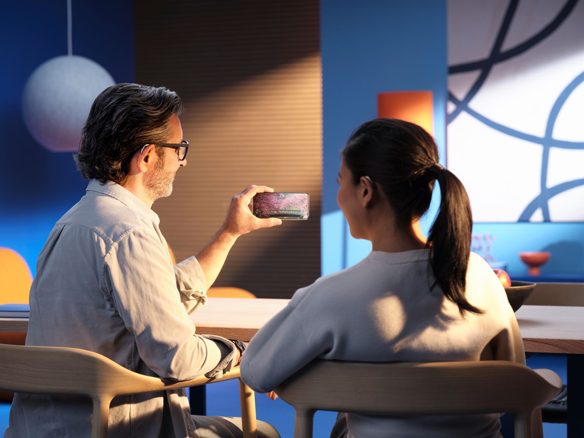 A Person is Holding a Hearing Aid in Their Hand — Clayton Hearing in Pialba, QLD