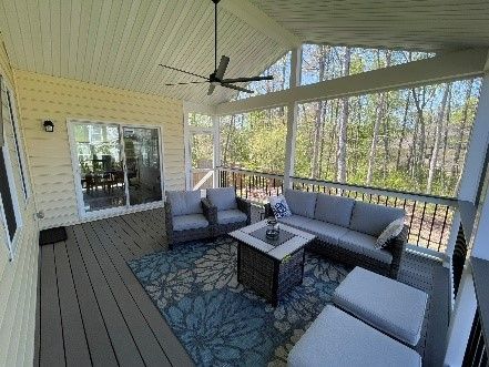 Residential deck builders are drilling a wooden deck.