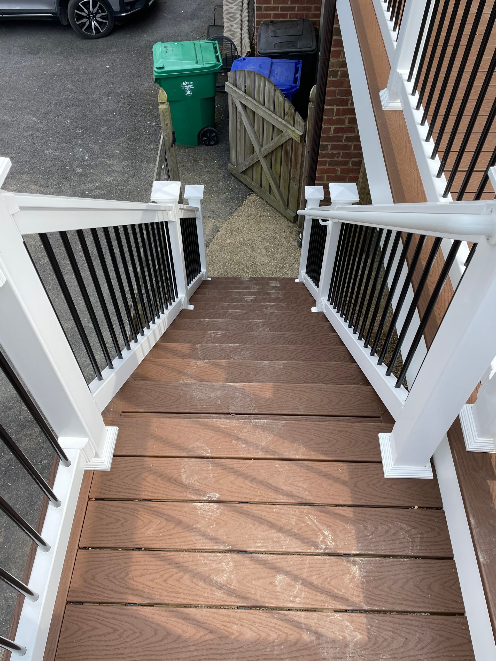 A set of wooden stairs leading up to a brick building