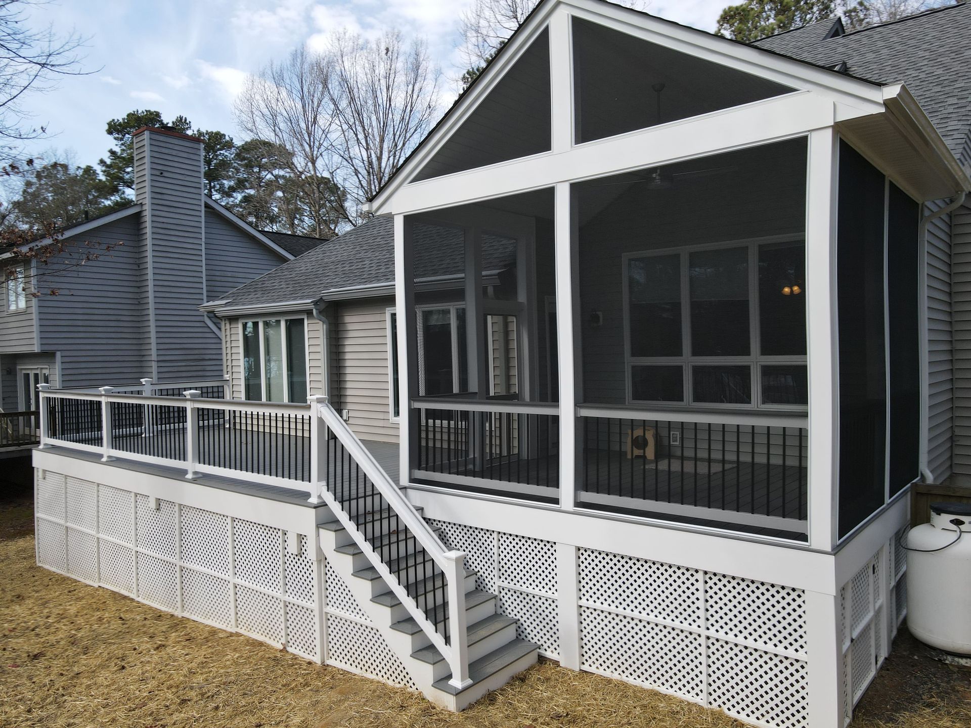A screened in porch with stairs leading up to it