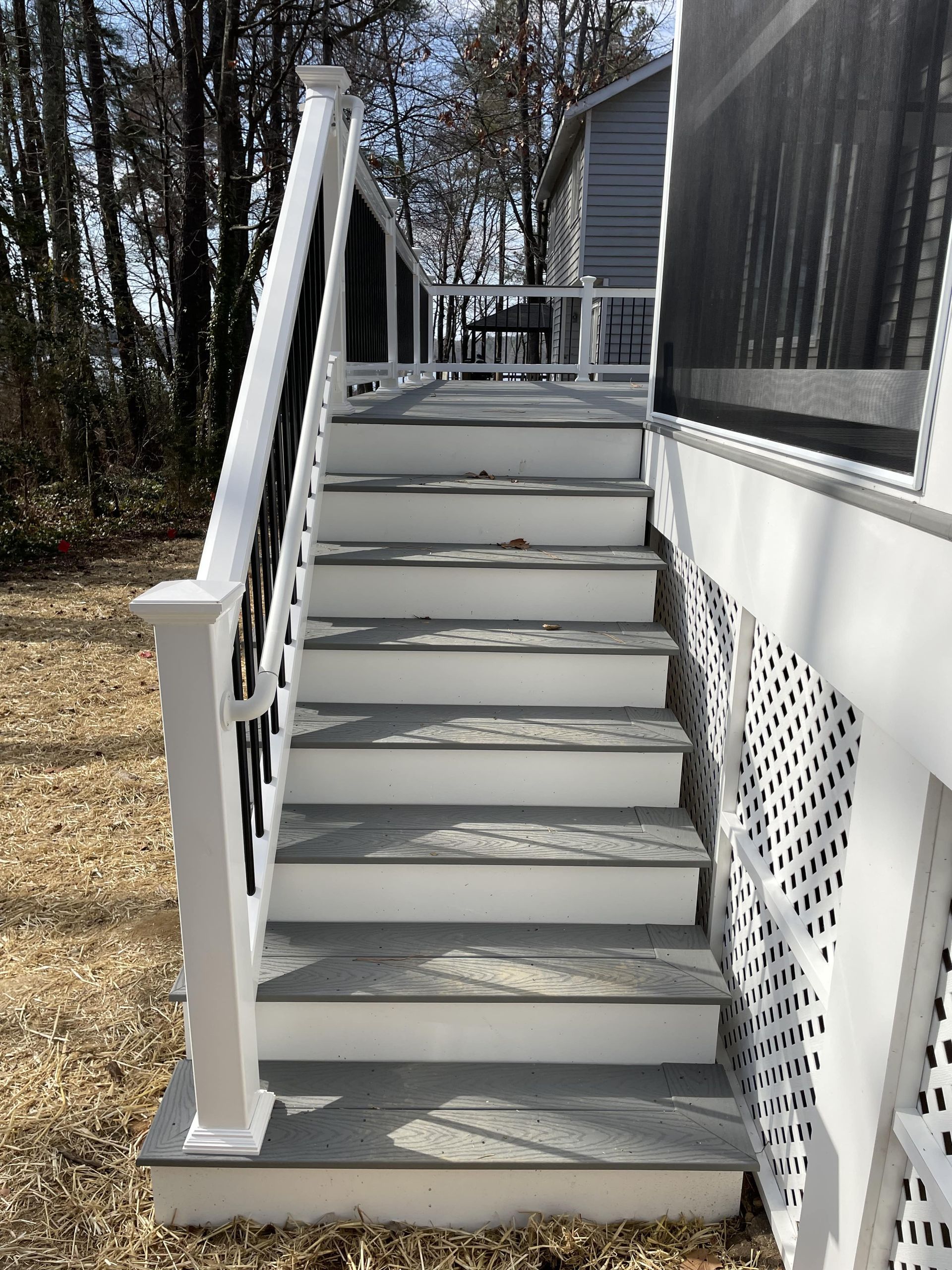 A set of stairs leading up to a screened in porch.