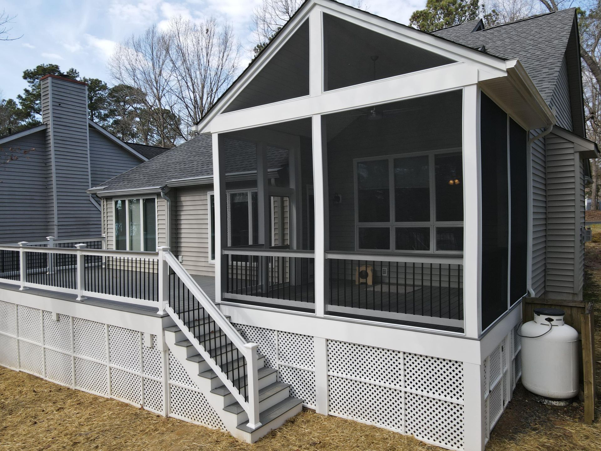 A screened in porch with stairs leading up to it