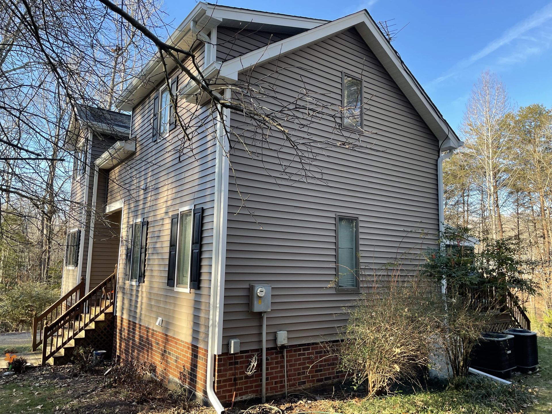 The back of a house with a lot of windows and stairs.