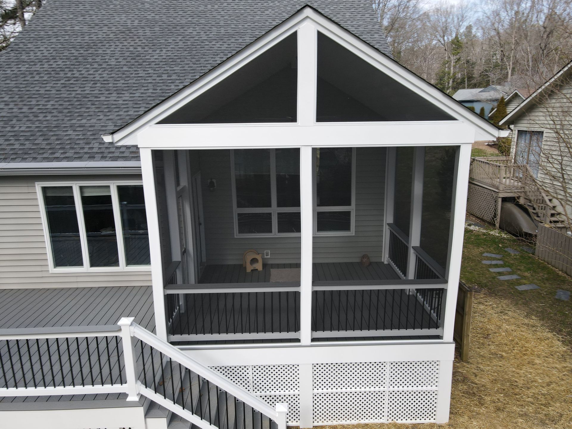 An aerial view of a screened in porch on the back of a house.