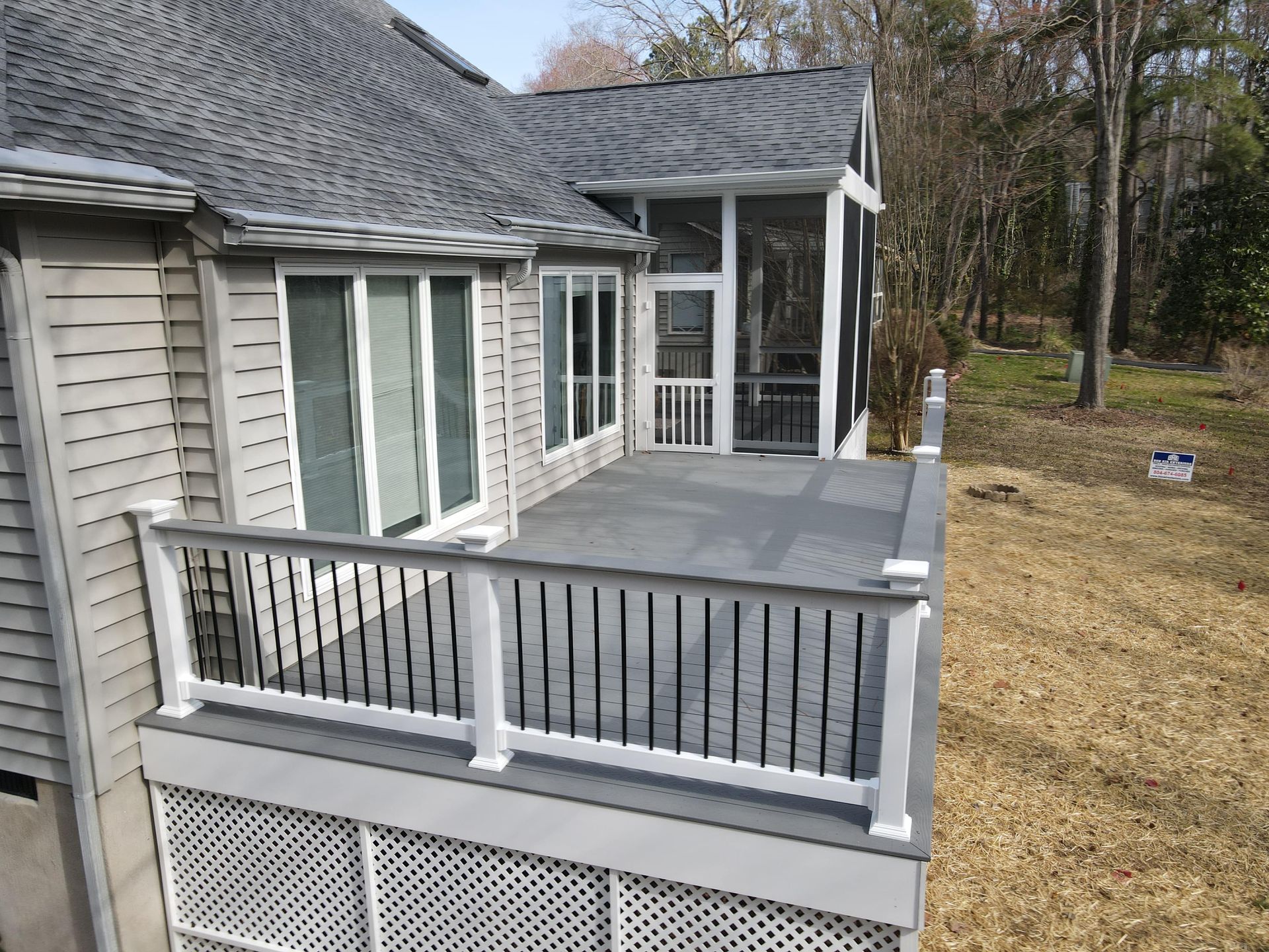 An aerial view of a screened in porch on the side of a house.