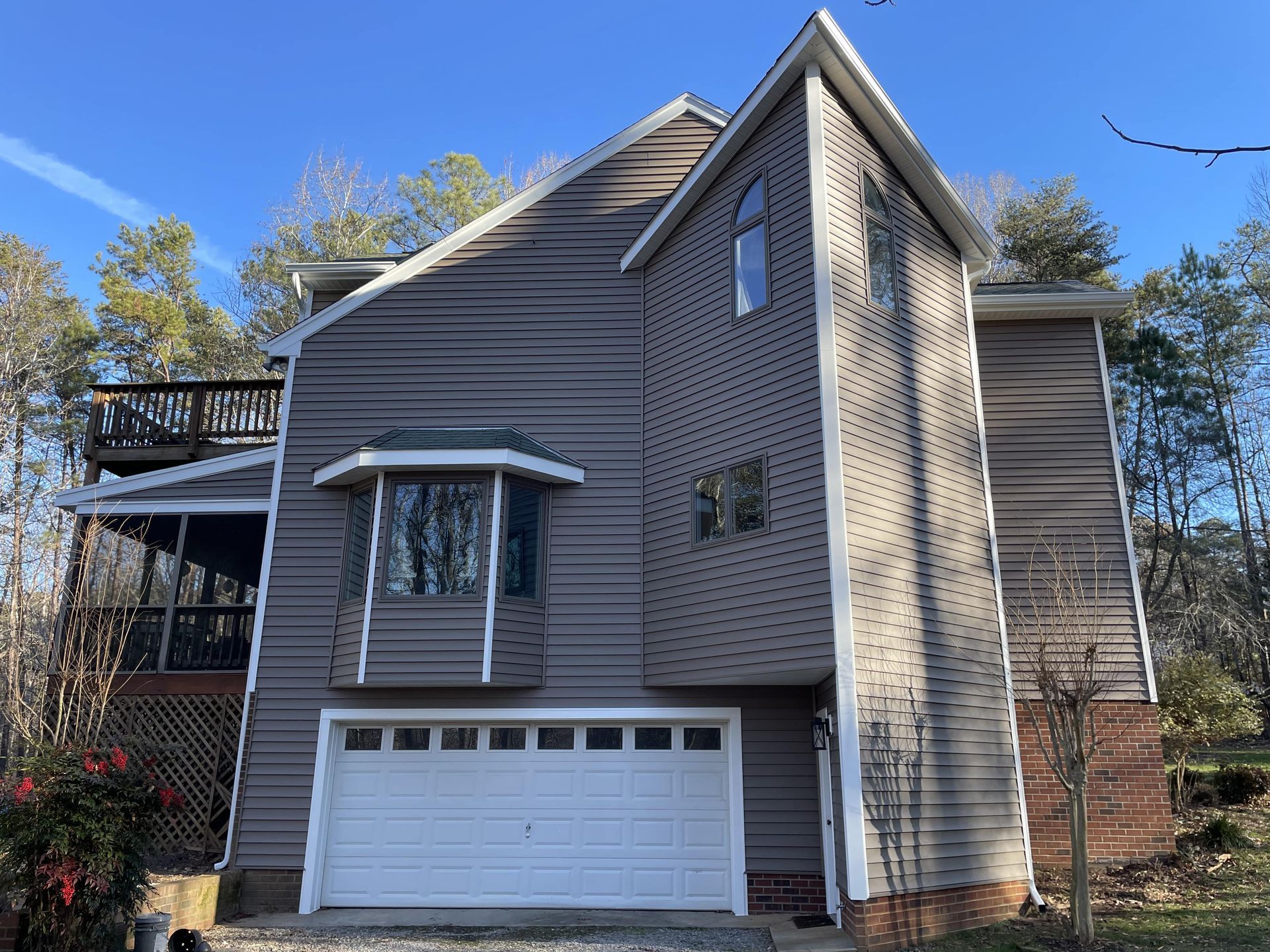 A large house with a garage and a balcony.