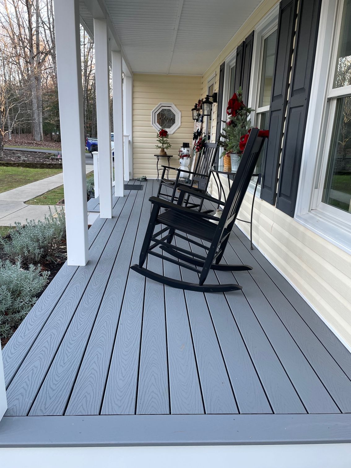 There is a rocking chair on the porch of a house.