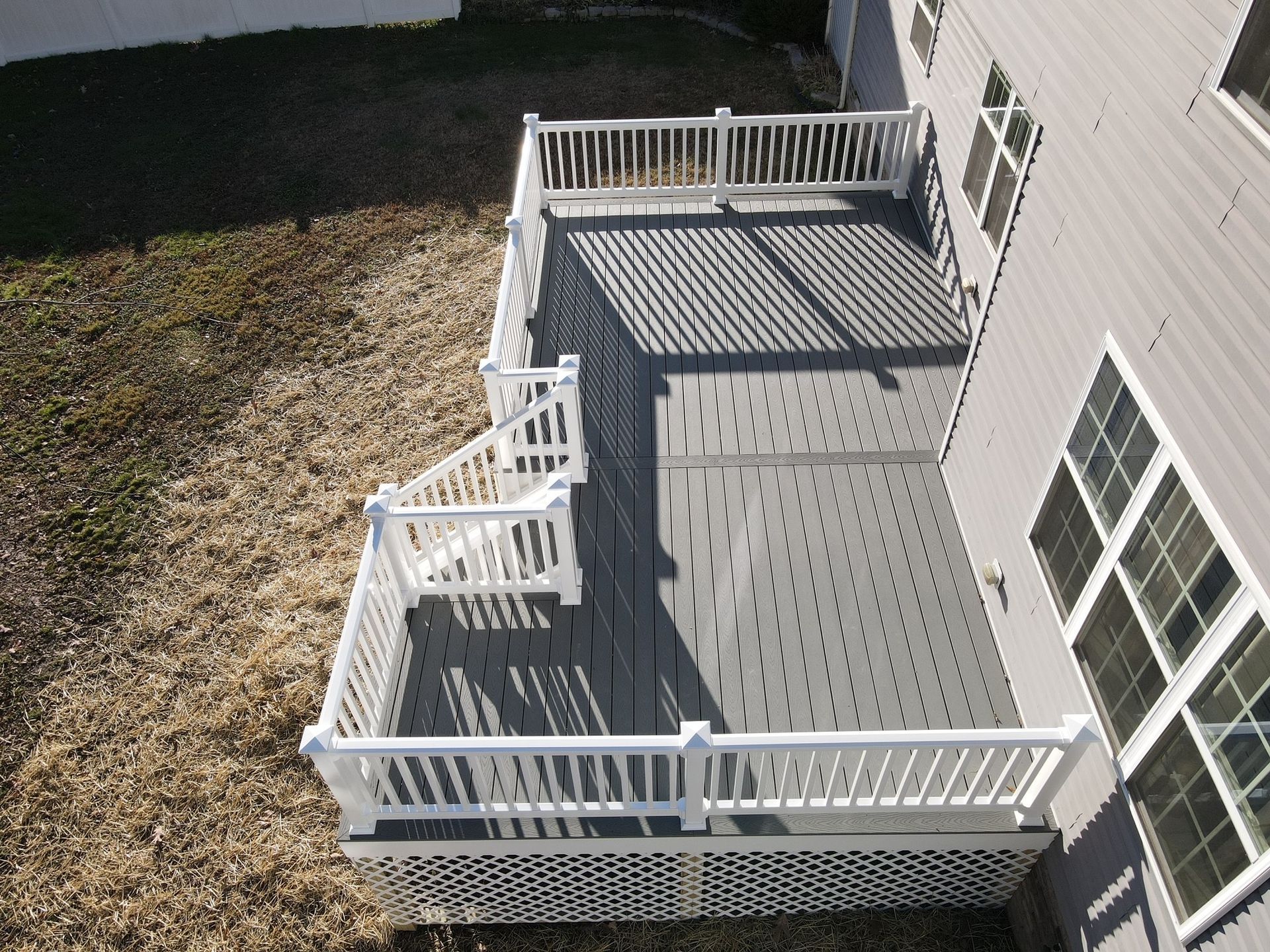 An aerial view of a deck with stairs and a white railing