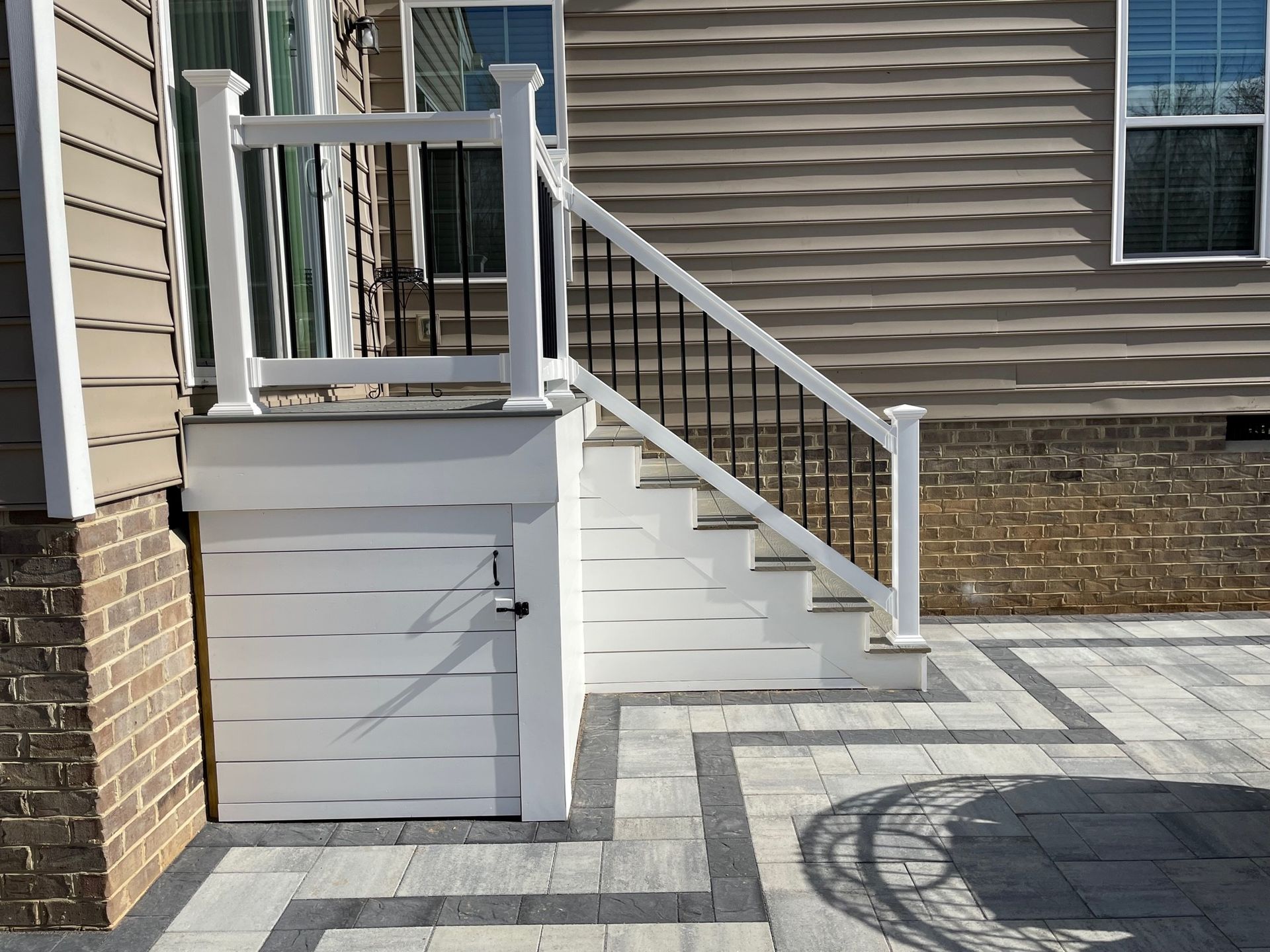 A white deck with stairs leading up to it