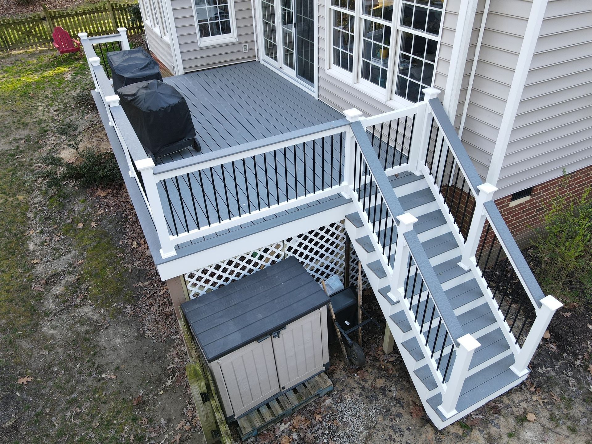 An aerial view of a house with a deck and stairs.