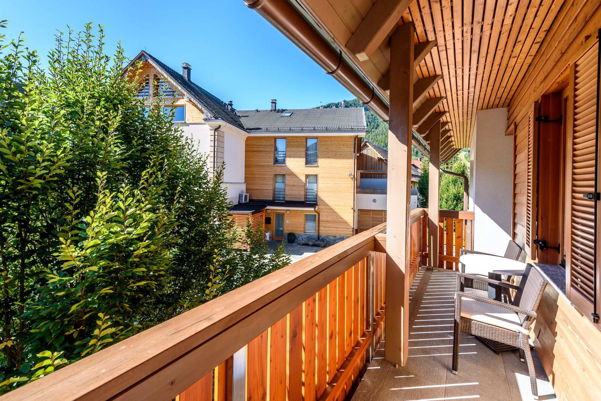 Deck with a wood railing and a tree in the background. | Residential Deck Builder in Richmond VA