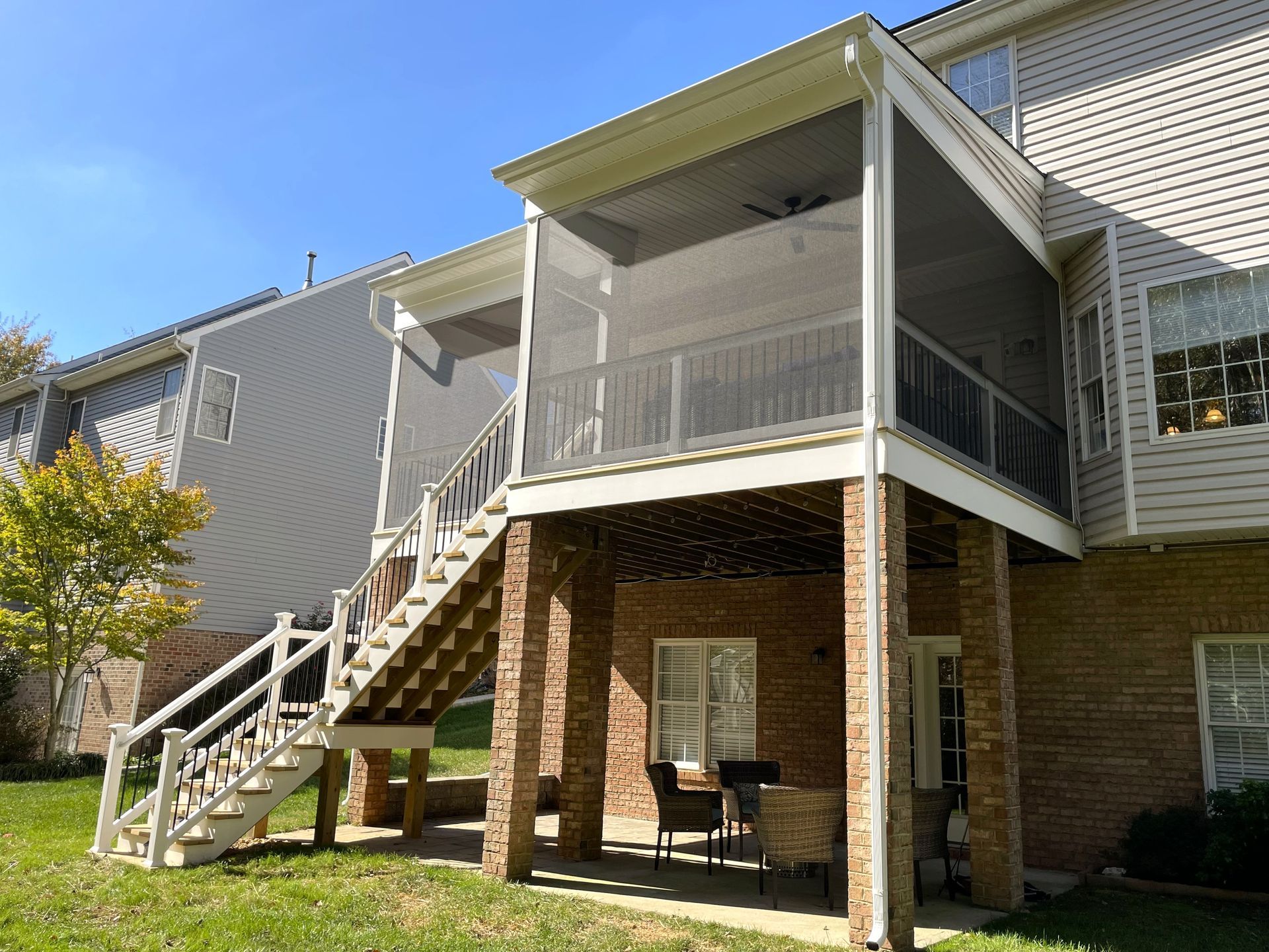 There is a screened in porch with stairs leading up to it.