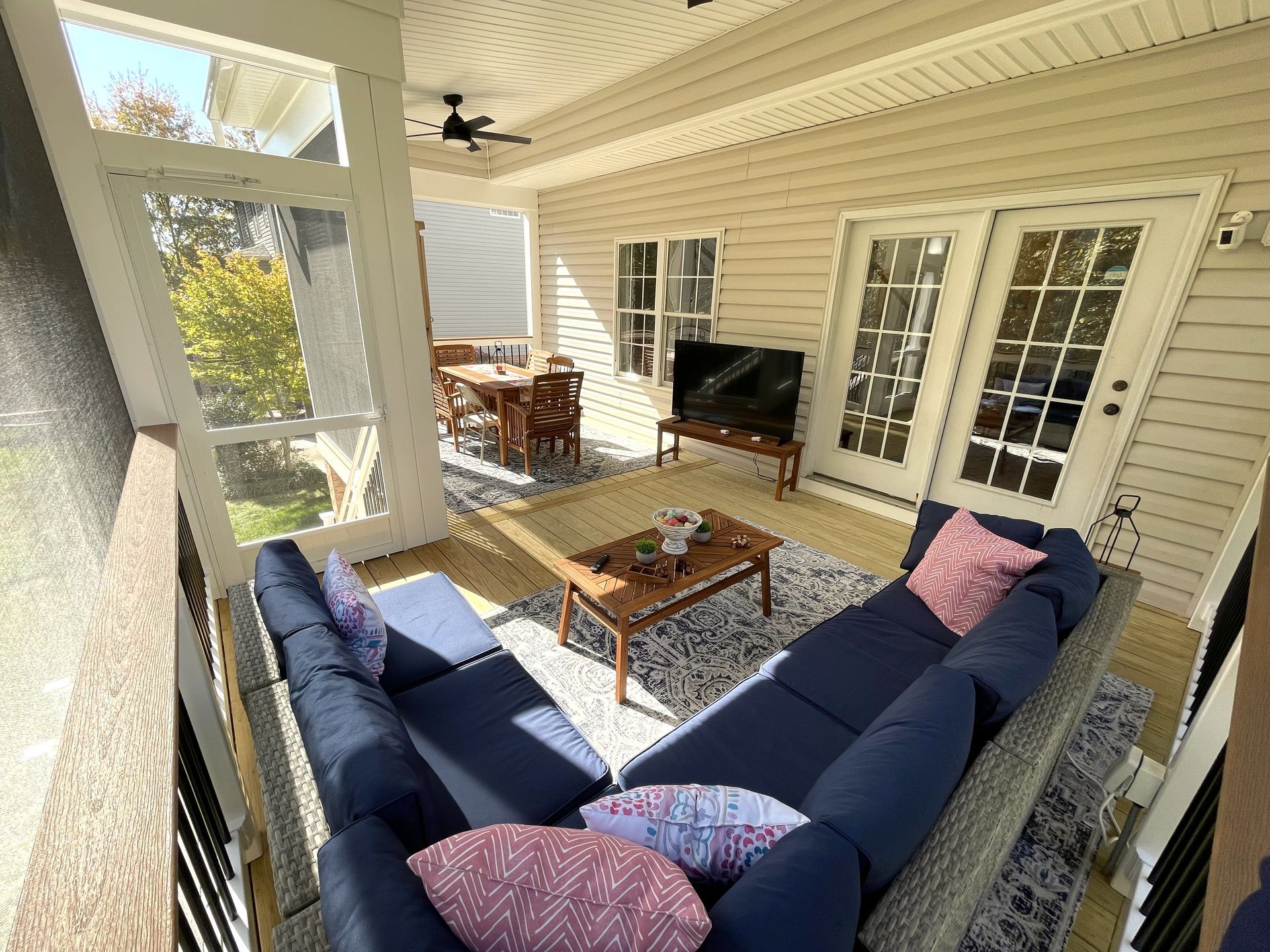 A living room with a couch , table , and television.