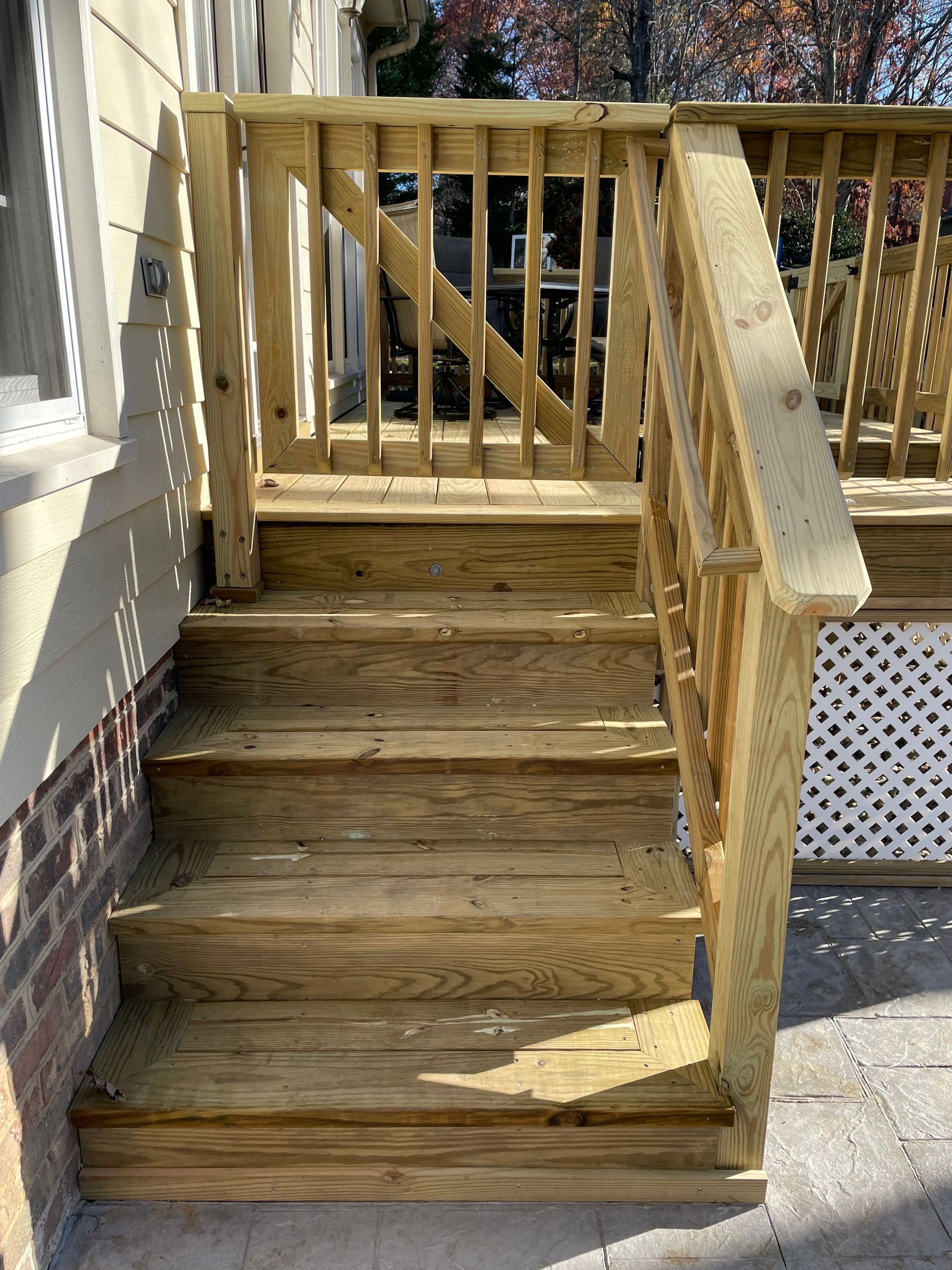 A wooden deck with stairs leading up to it.