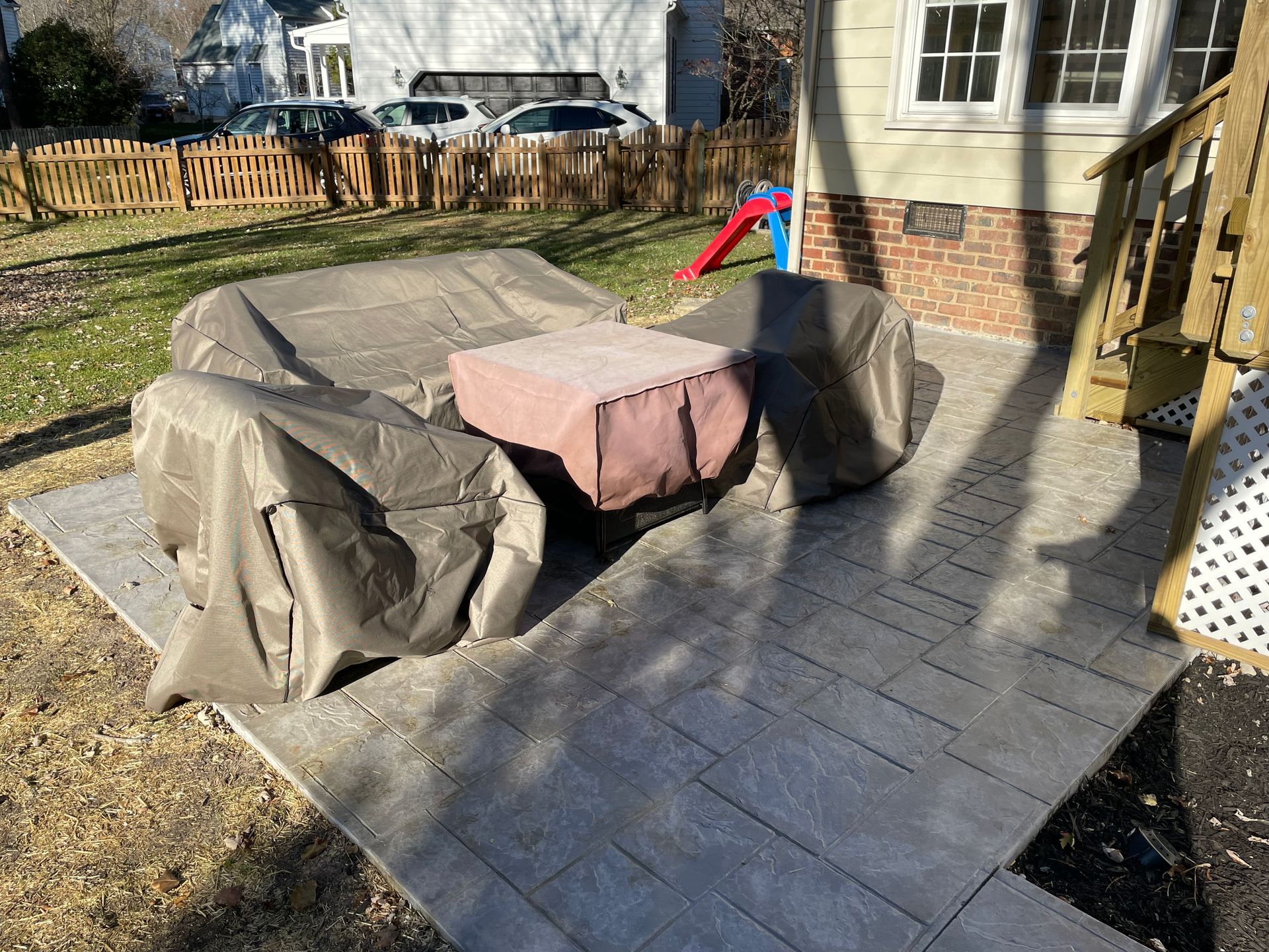 A patio with a table and chairs covered in a cover.
