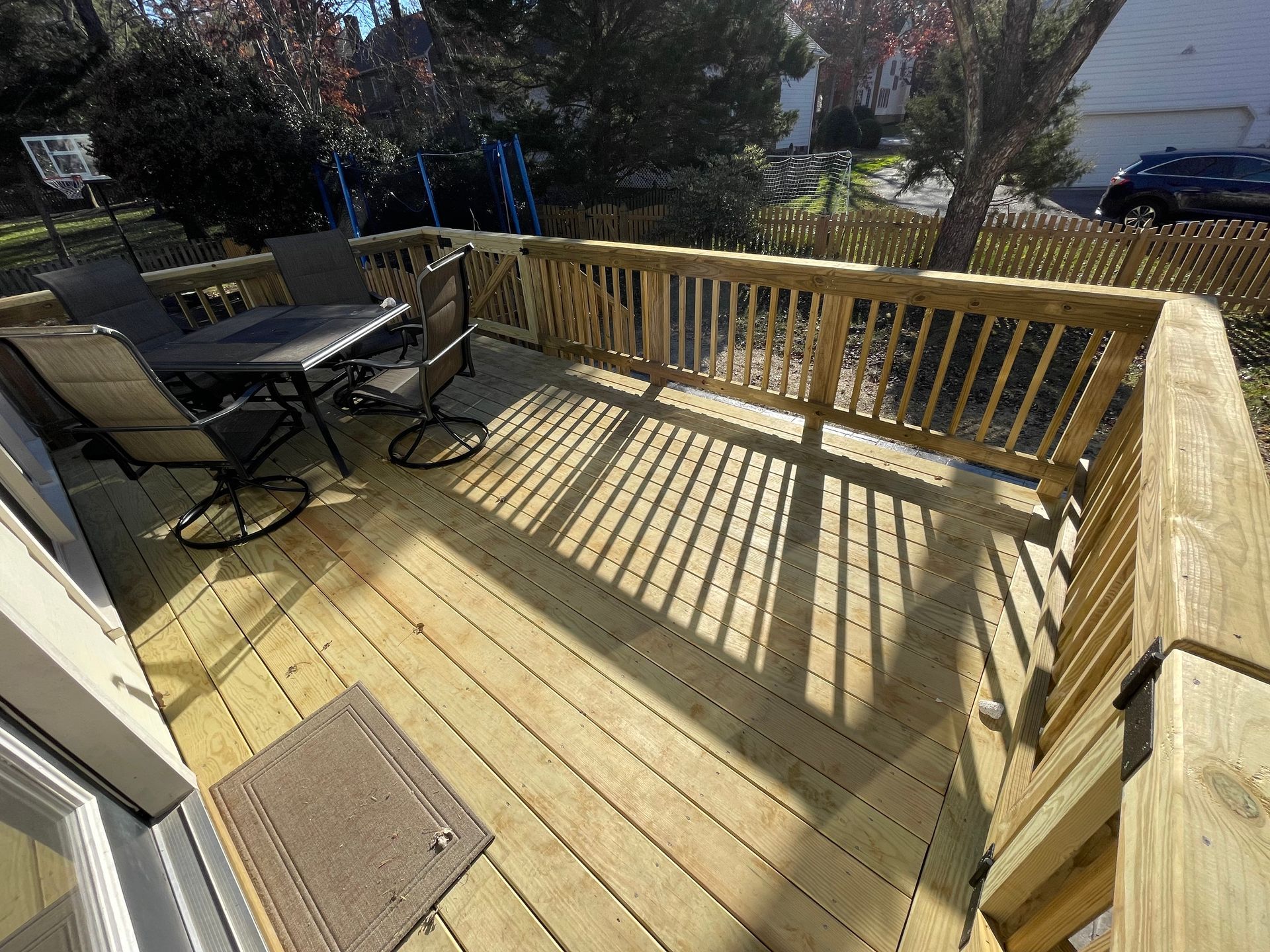 A wooden deck with a table and chairs on it