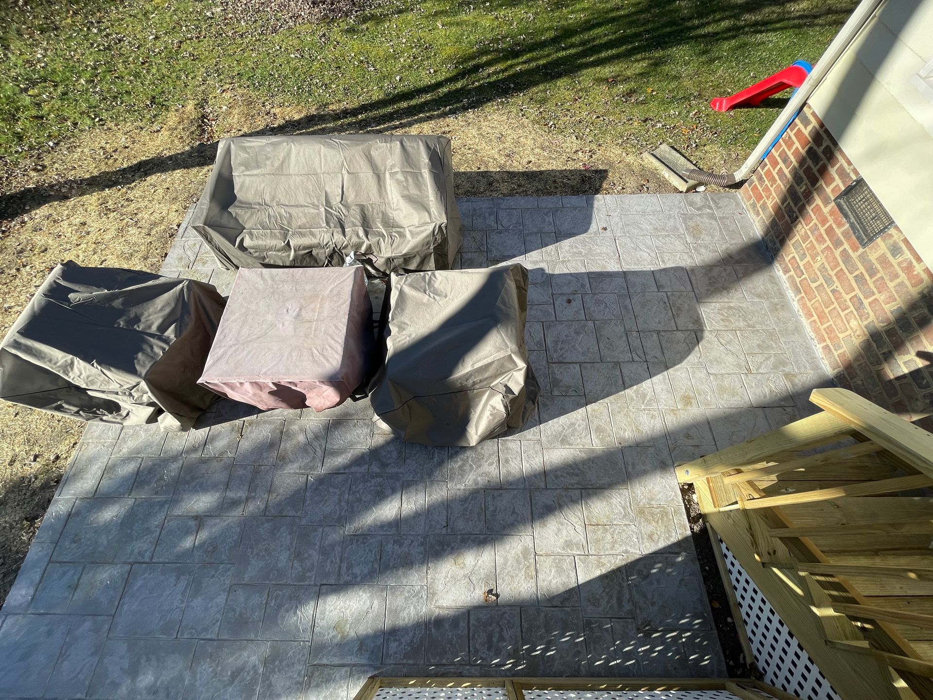An aerial view of a patio with chairs and a table.