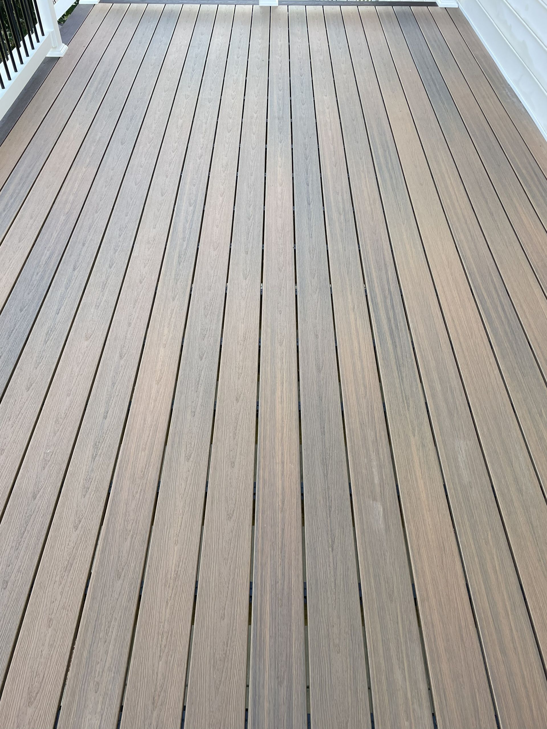 Wooden deck with long, narrow, parallel planks.