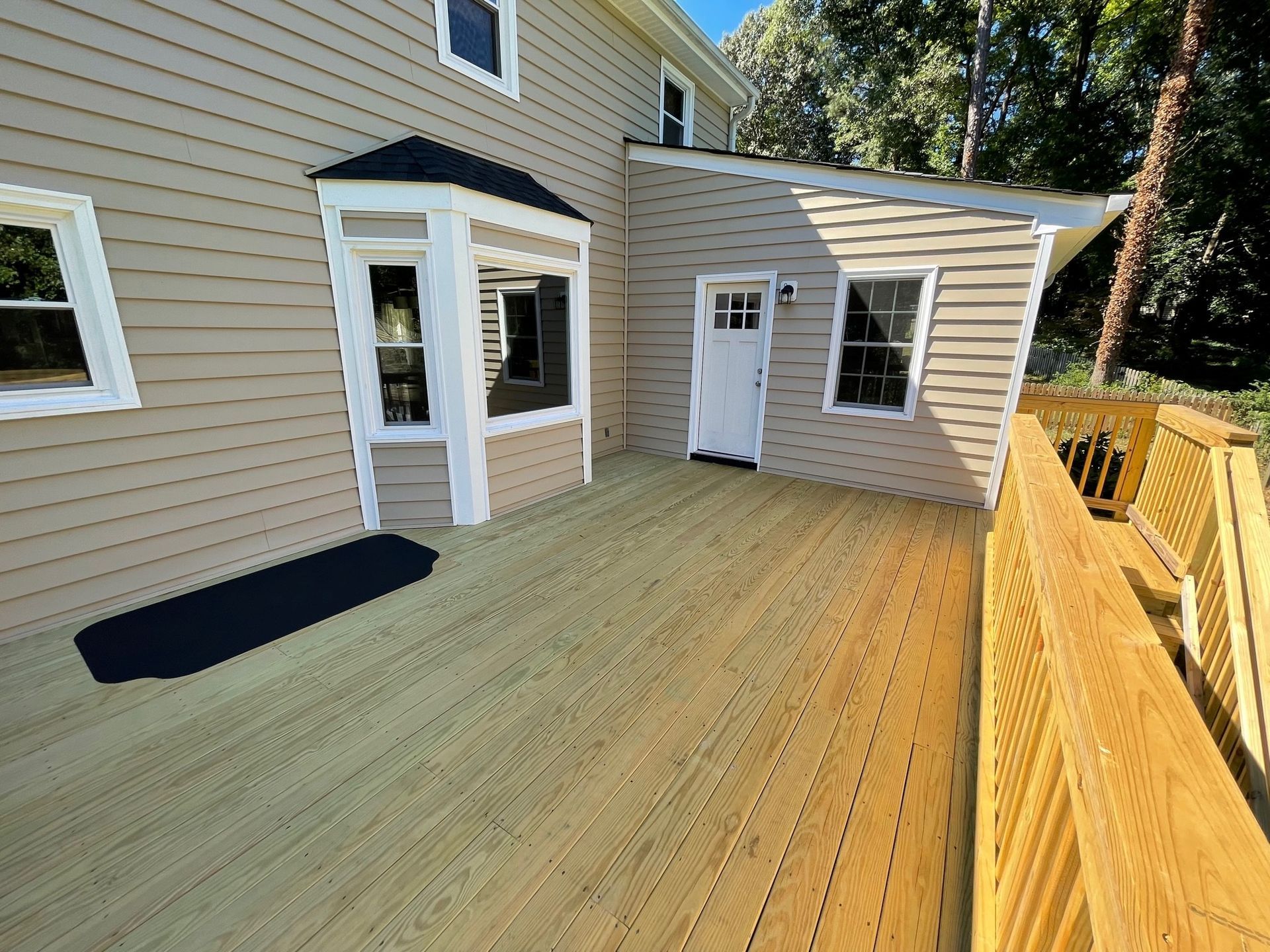 A house with a wooden deck in front of it