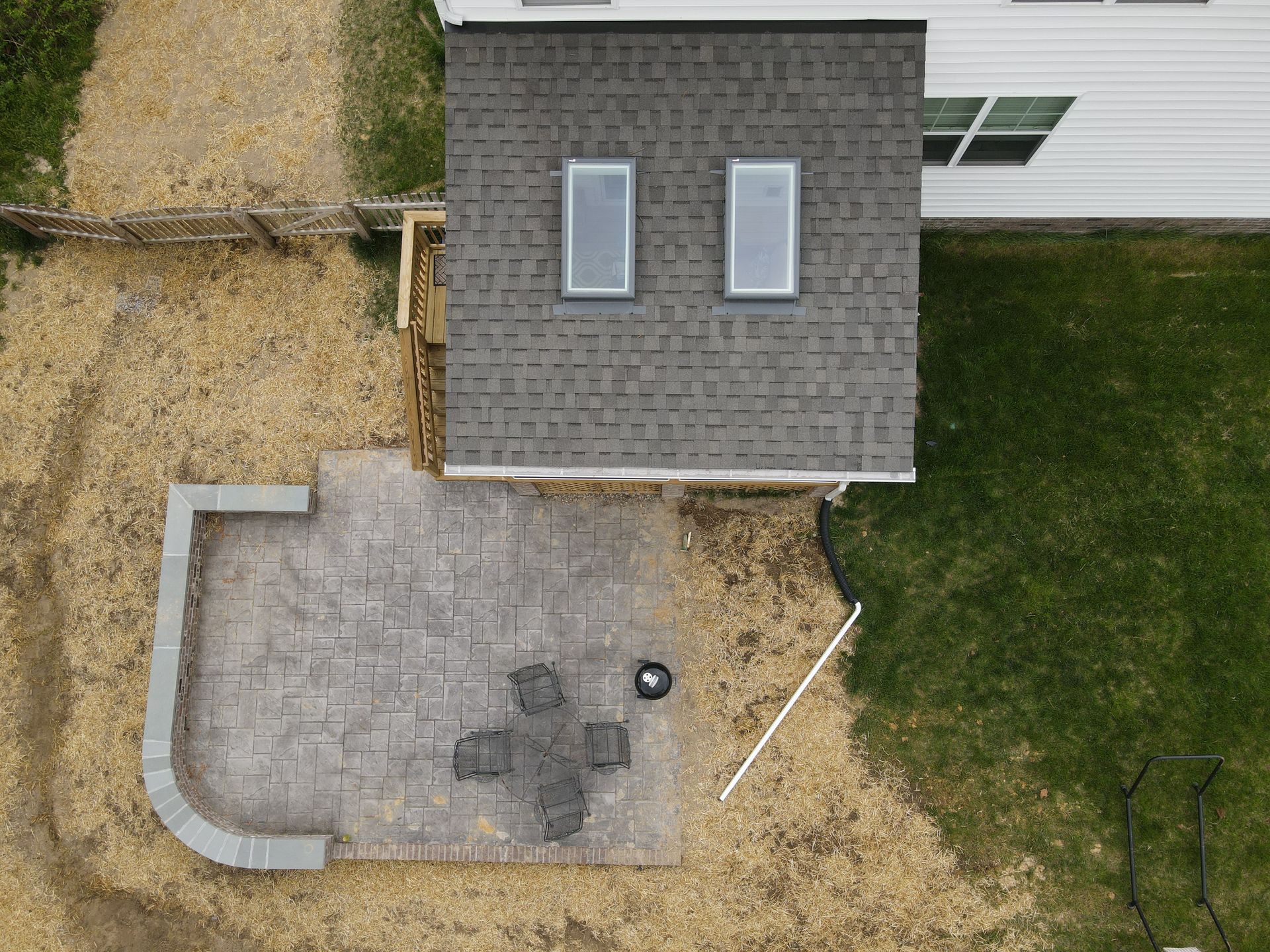 An aerial view of a house with a patio in front of it.