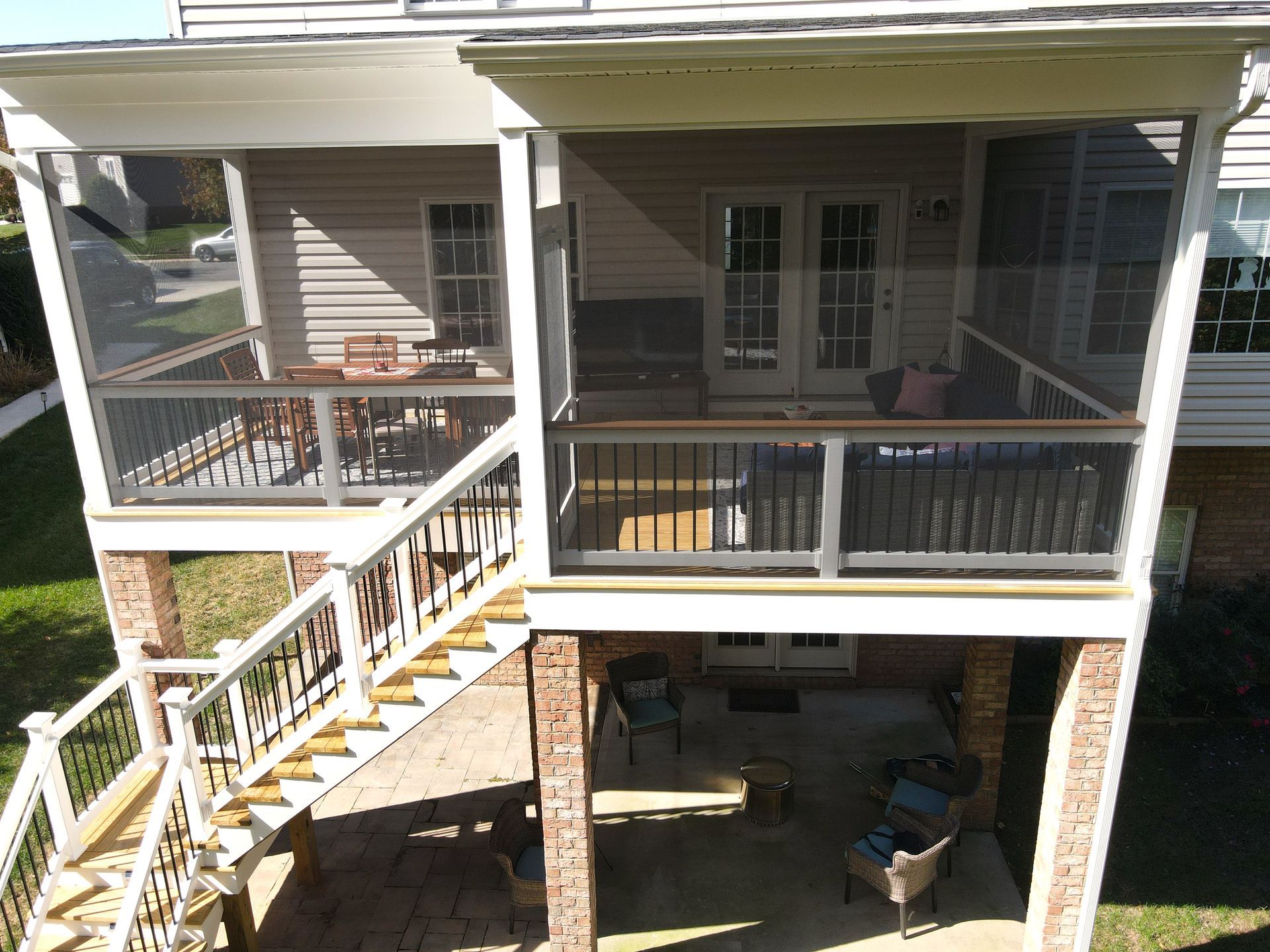 A house with a screened in porch and stairs