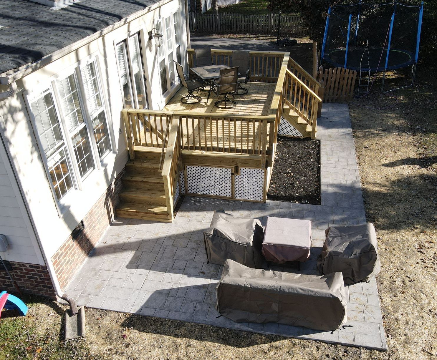 An aerial view of a backyard with a deck and stairs