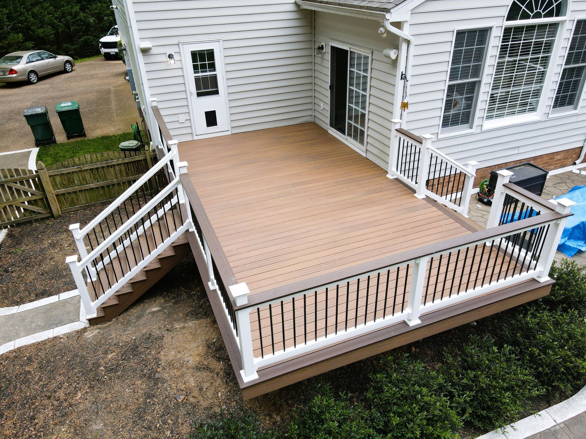 An aerial view of a large wooden deck with stairs leading up to it.