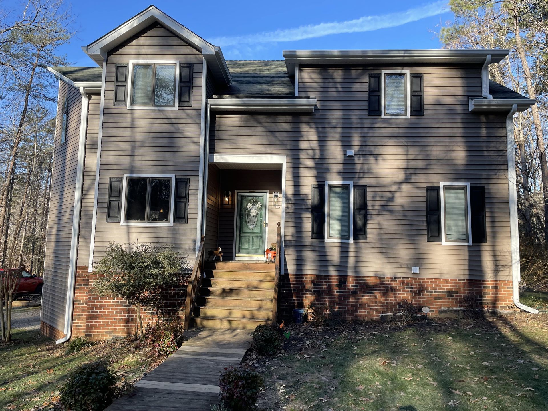 A large house with a lot of windows and a green door