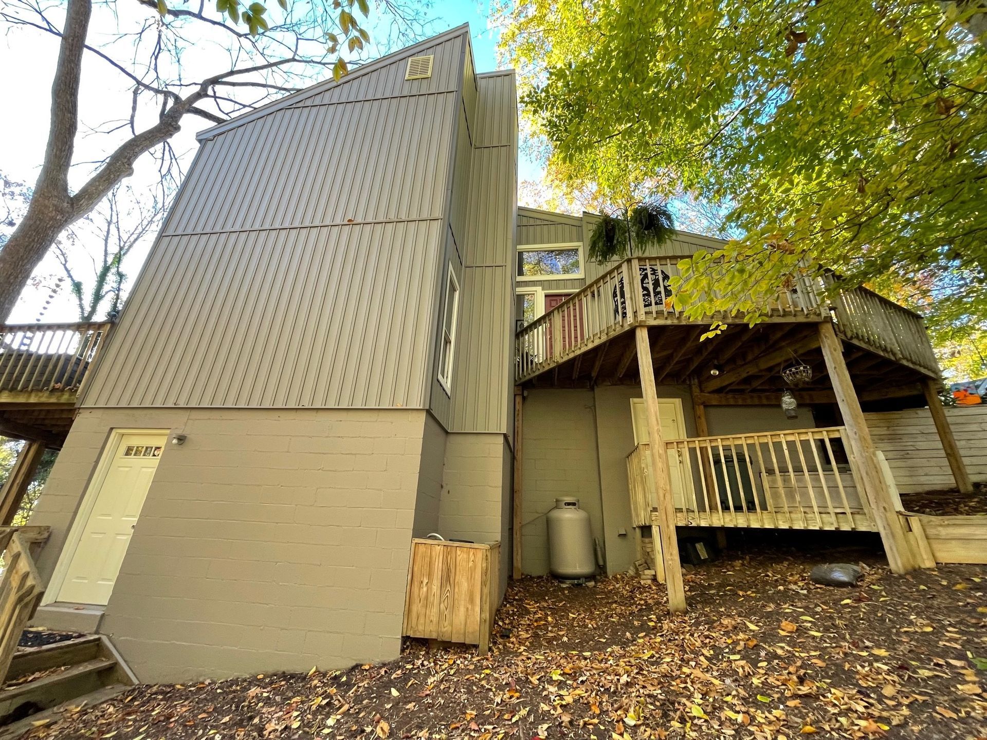 The back of a house with a deck and stairs.