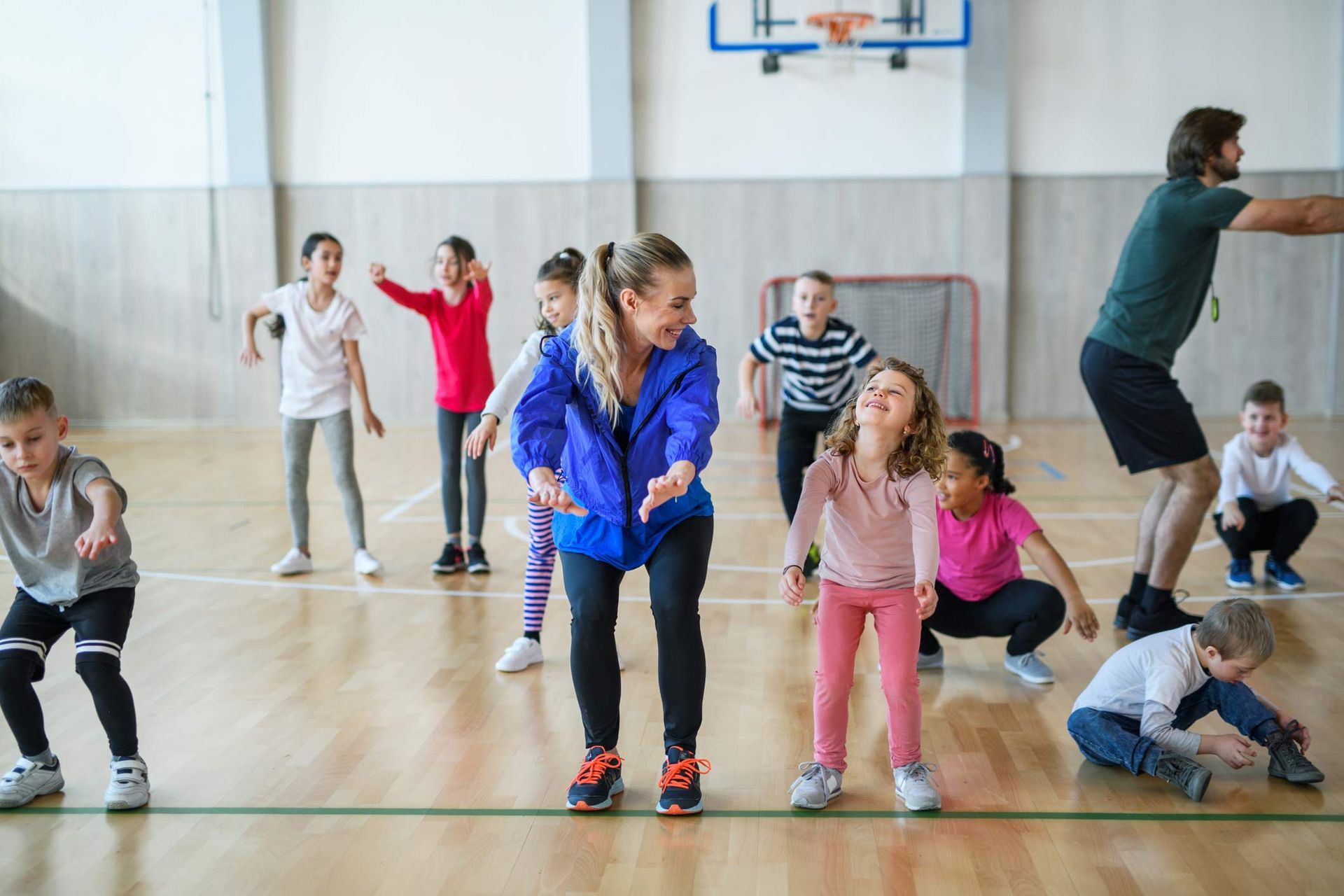 A Group Of Children Are Dancing In A Gym With A Teacher — Kenmore, NY — Buffalo Turners Gymnastics