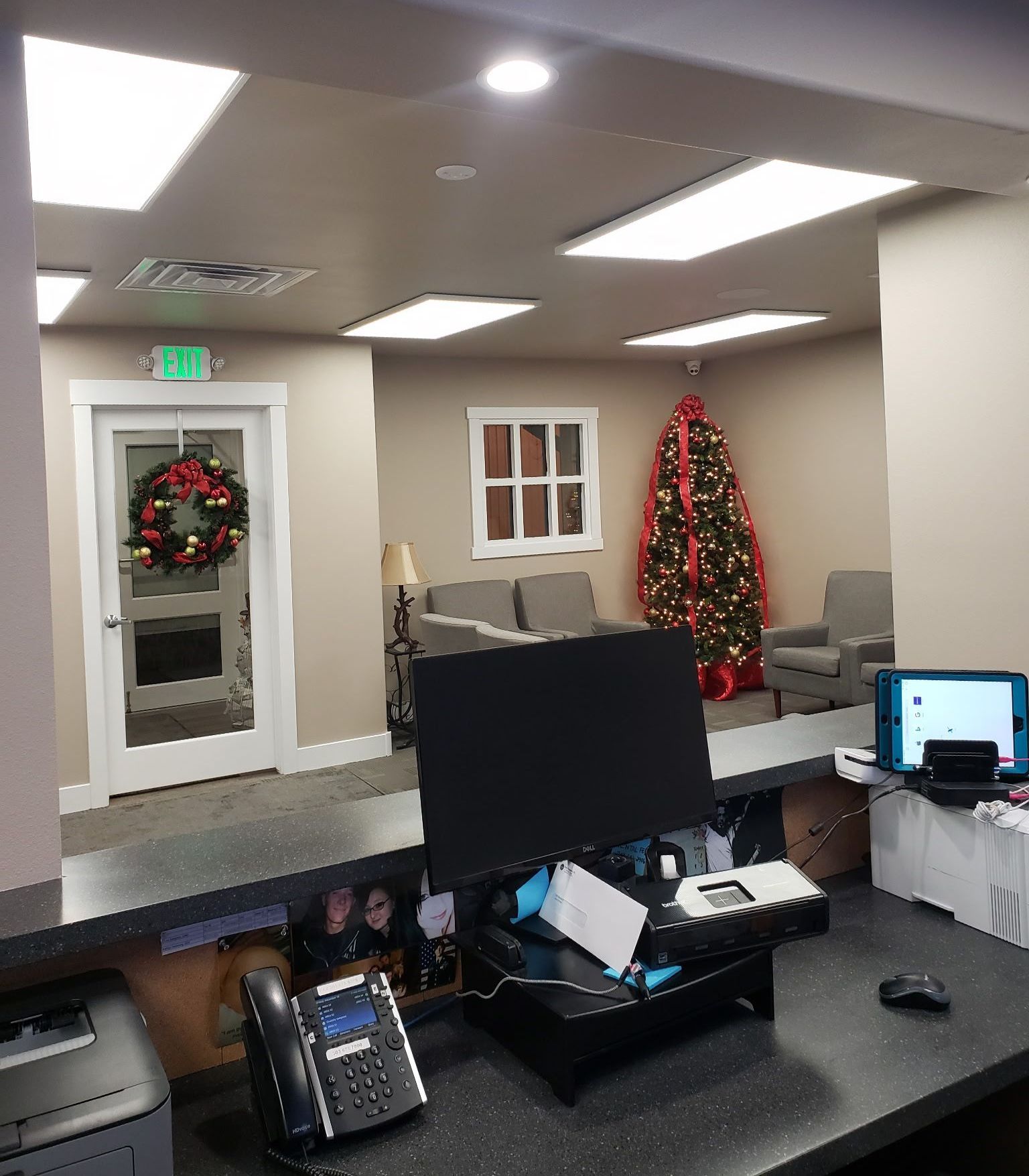 A waiting room with a christmas tree in the background