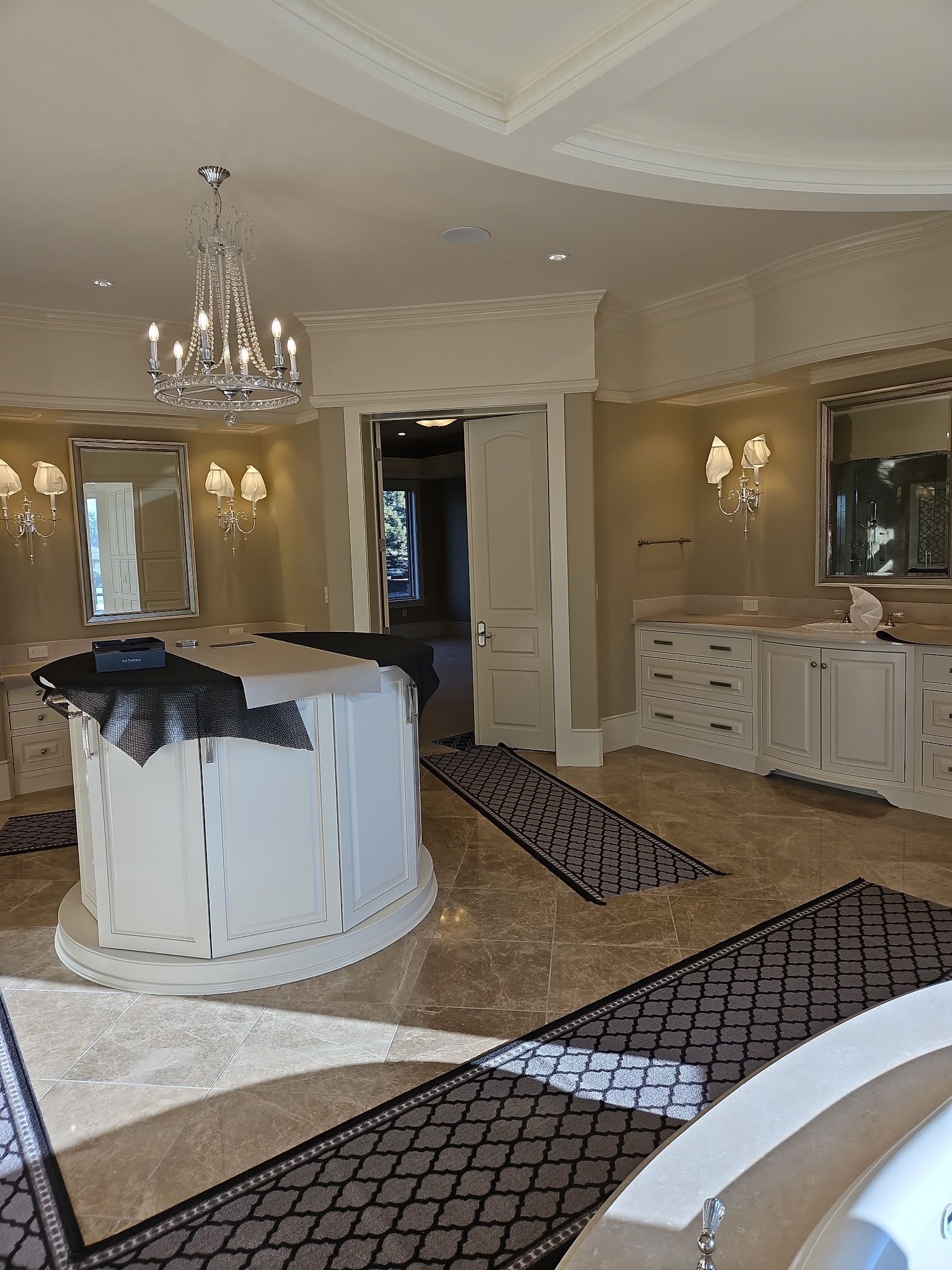 A large bathroom with a large tub and a chandelier