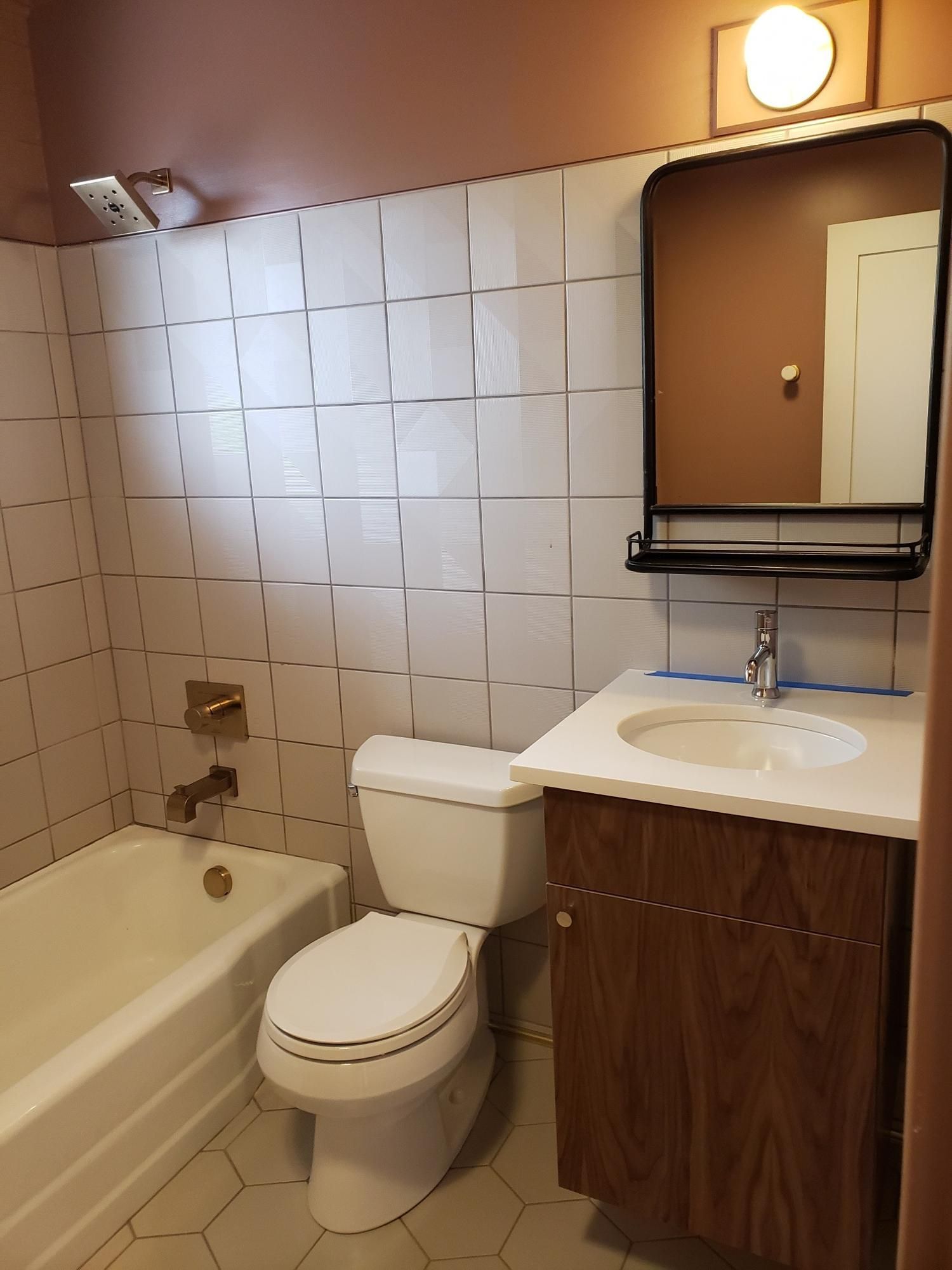 A bathroom with a toilet a sink and a bathtub