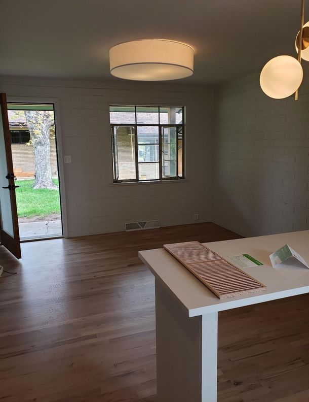 An empty room with a table and a window