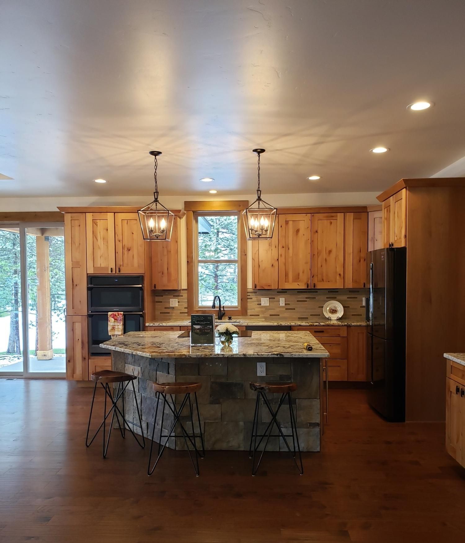 A kitchen with wooden cabinets and granite counter tops